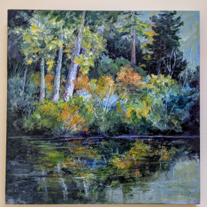 Acryclic painting of a forest-edged lake on wall of a gallery